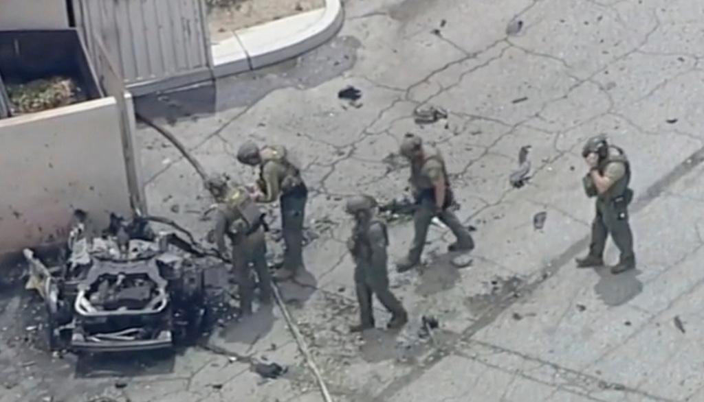 Law enforcement investigate a vehicle after an explosion on Saturday, May 17, 2025 in Palm Springs, Calif. 