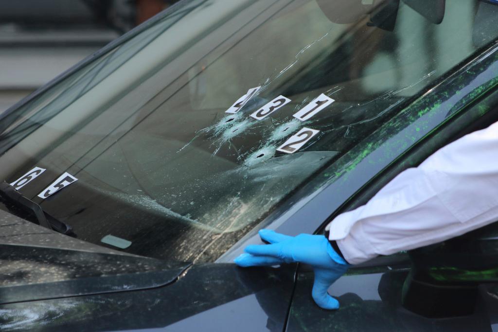 Crime scene investigators work at the site where the personal secretary and an advisor to Mexico City's mayor were killed by gunmen on a motorcycle, in Mexico City