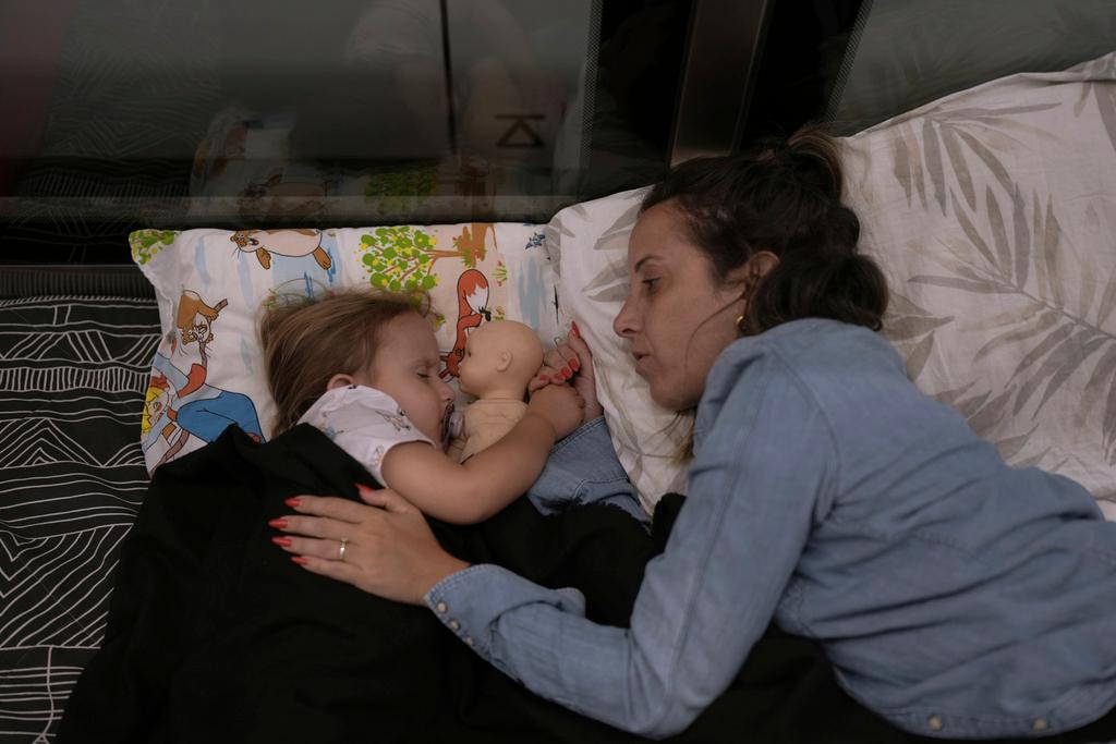 Tehila Alush, and her daughter Ariel Asraf, 3, take shelter in an underground metro station as a precaution against possible Iran missile attacks, in Ramat Gan, near Tel Aviv