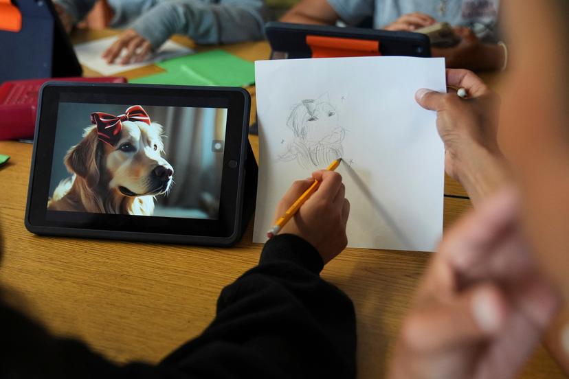 A student talks with art teacher Lindsay Johnson about how to ask Canva for help during a summer class at Roosevelt Middle School in River Forest, Ill. 