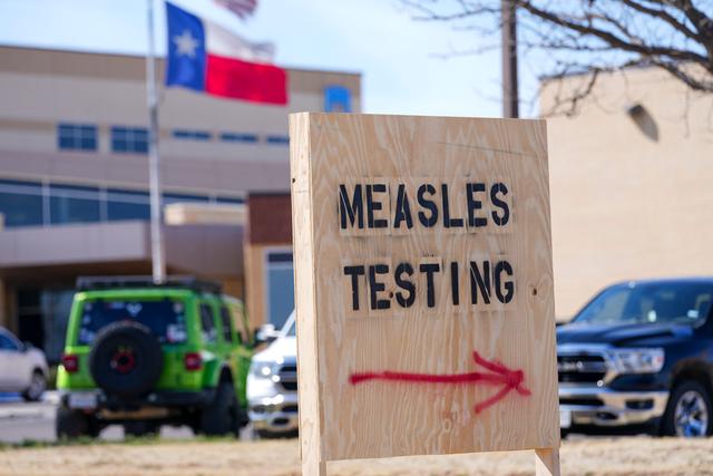 Sign is displayed outside the Seminole Hospital District offering measles testing in Seminole, Texas