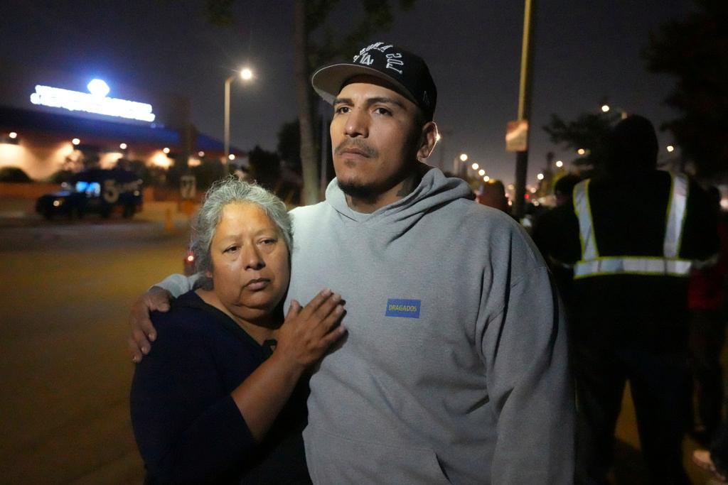 Maria Orozco hugs her son, Oraldo Orozco, one of her three sons who were trapped as tunnel workers inside a collapsed tunnel under construction for Los Angeles County's Clean Water project,