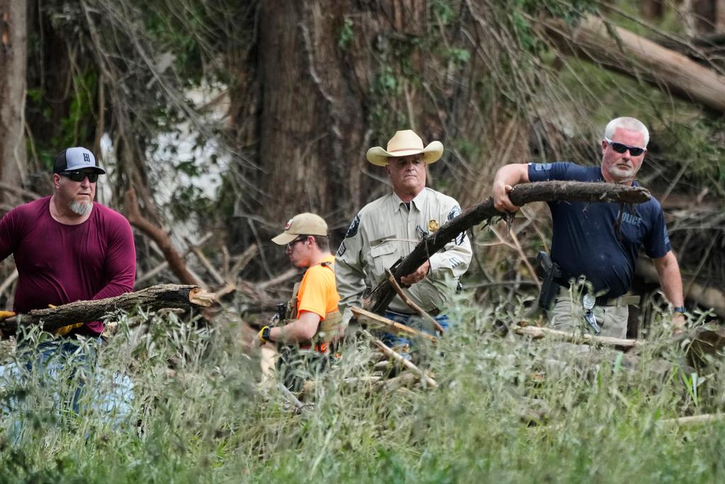 Law enforcement assists during search and clean-up efforts after flooding in Center Point, Texas