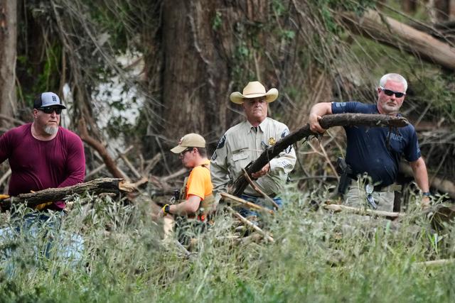 Law enforcement assists during search and clean-up efforts after flooding in Center Point, Texas