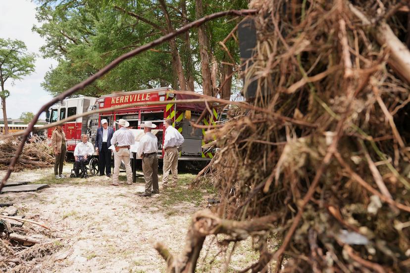 First lady Melania Trump, from left, Texas Gov. Greg Abbott and President Donald Trump are briefed on flood damage in Kerrville, Texas