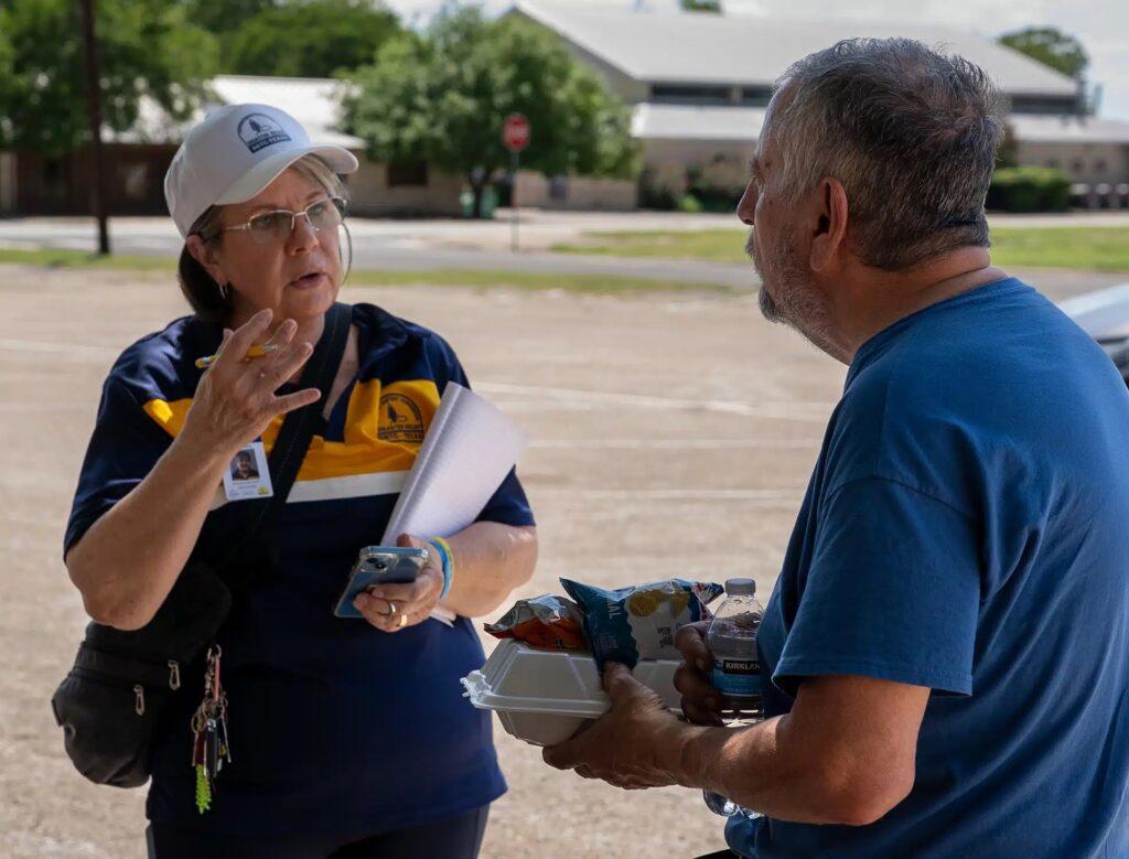 Debra Britt, an SBTC DR "white hat"—the person in charge of all disaster relief operations on site—speaks with a man at FBC Kerrville earlier this week. 