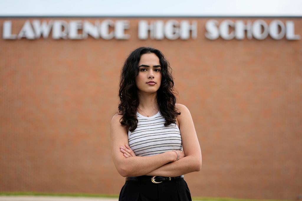 Natasha Torkzaban stands outside Lawrence High School, where she and other students have filed a lawsuit against the school district's use of digital surveillance software in Lawrence, Kan. 