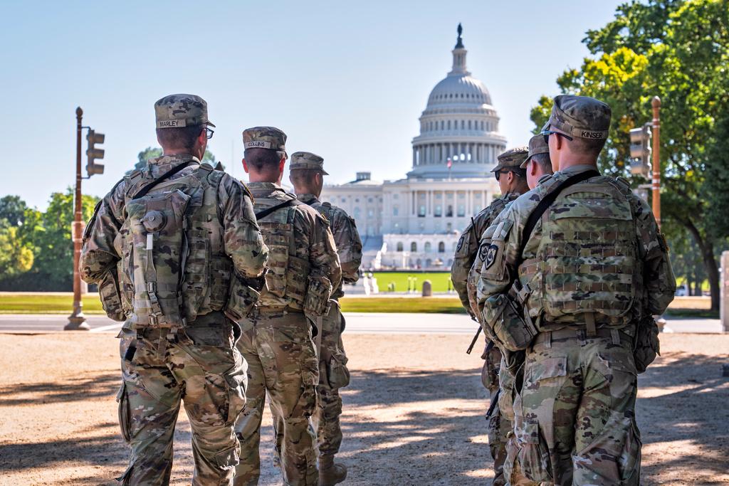 Armed National Guard soldiers from West Virginia patrol the Mall near the Capitol in Washington