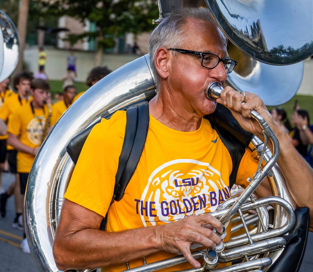 Kent Broussard performs with The Golden Band from Tigerland as they head down Victory Hill 