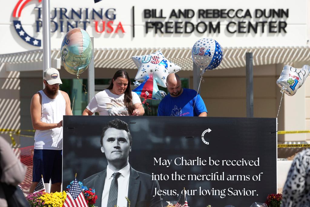 Well-wishers add balloons to a makeshift memorial set up at Turning Point USA headquarters 