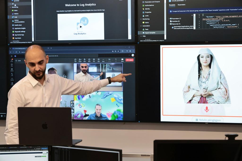 Enio Kaso, head of the Department of Artificial Intelligence and Cryptocurrency Licensing shows the AI "minister" Diella, whose name means "Sun" in Albanian