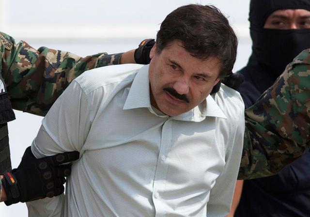 (2014) Joaquin "El Chapo" Guzman, the head of Mexico's Sinaloa Cartel, being escorted to a helicopter in Mexico City following his capture