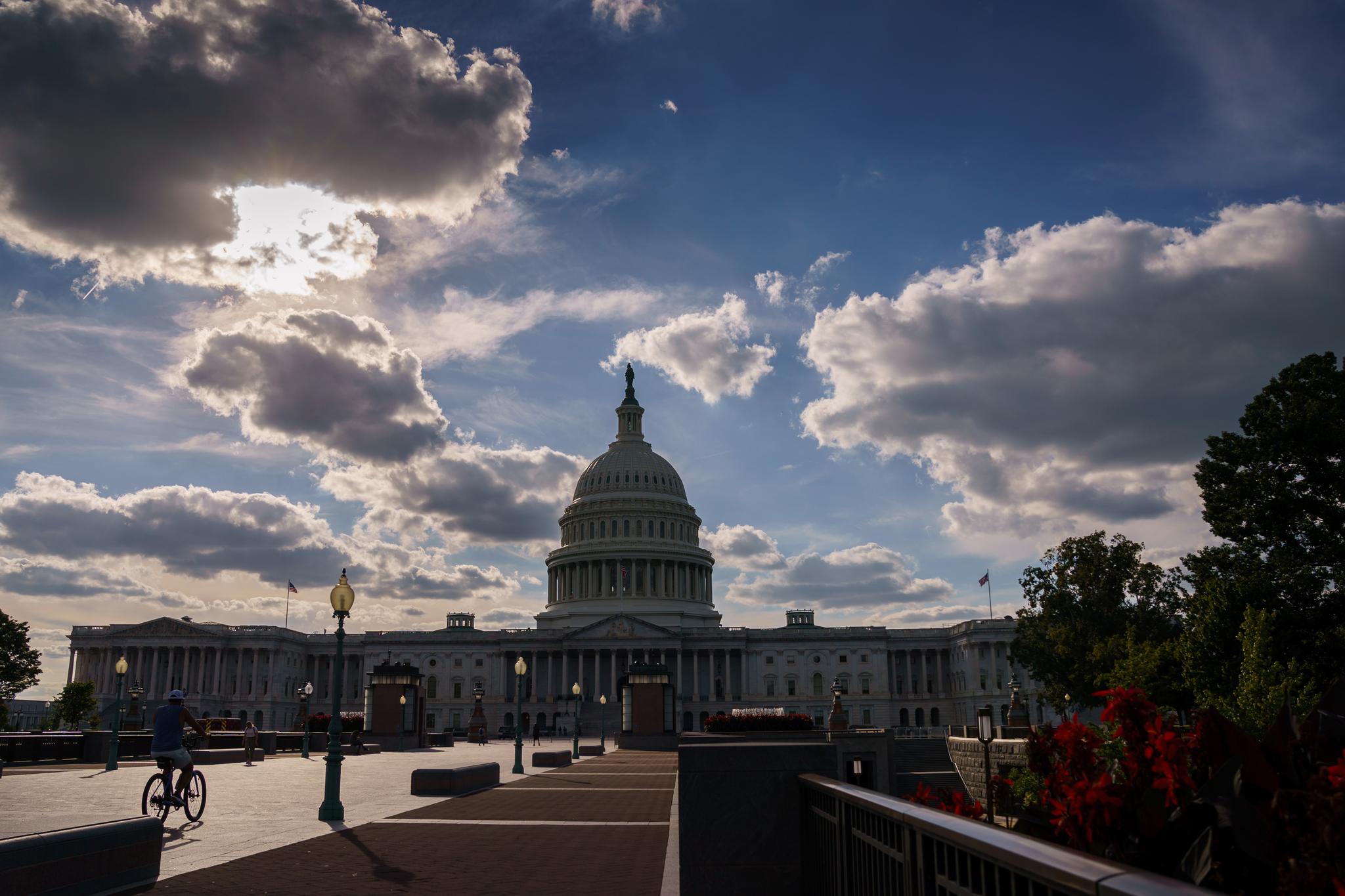 The U.S. Capitol building with thick clouds around it