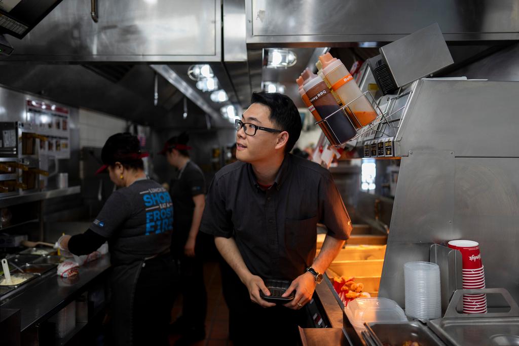 Lawrence Cheng, whose family owns seven Wendy's locations south of Los Angeles, works in the kitchen at his Wendy's restaurant in Fountain Valley, Calif., June 20, 2024.