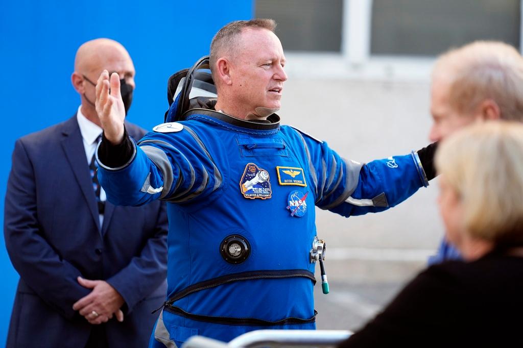 NASA astronaut Butch Wilmore gestures as he talks to family members after leaving the operations and checkout building for a trip to launch pad at Space Launch Complex 41