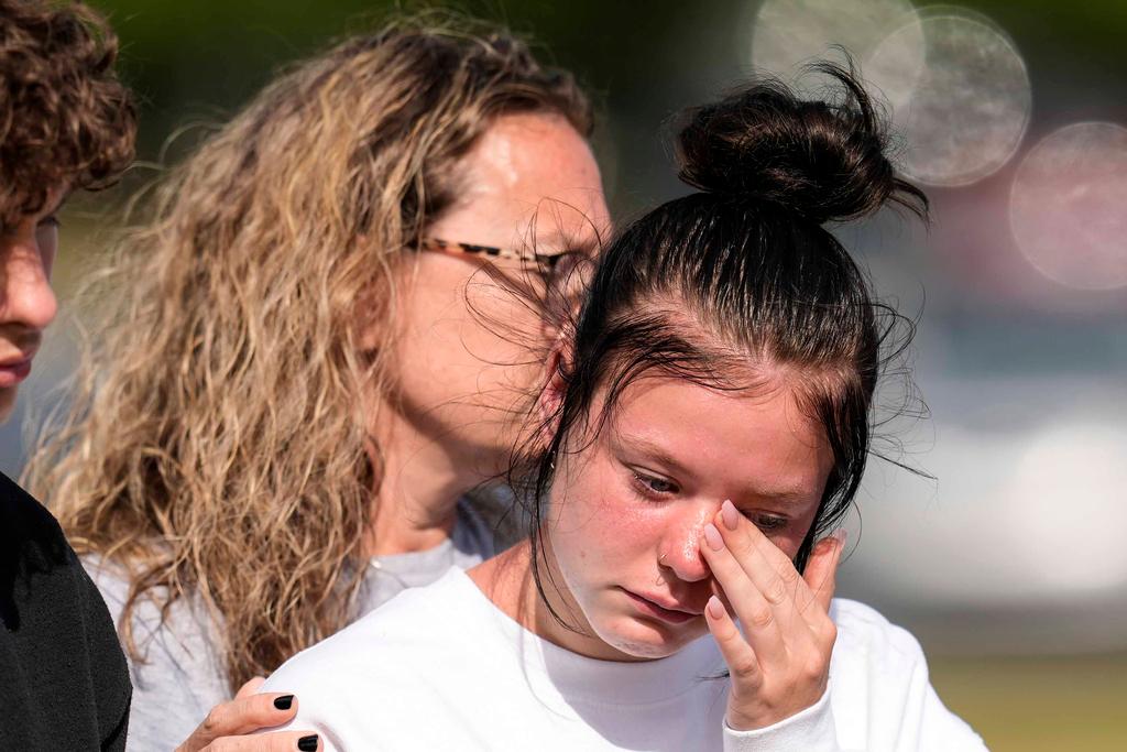 Student weeps at a makeshift memorial at Apalachee High School