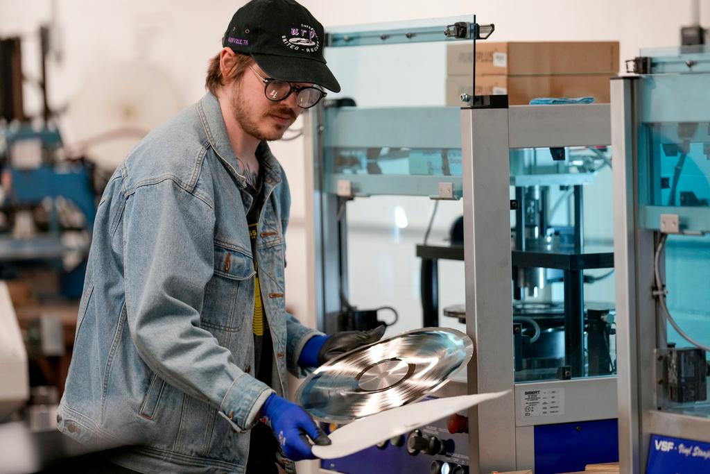 Graham Purrell prepares a master plate for creating vinyl records at the United Record Pressing plant 
