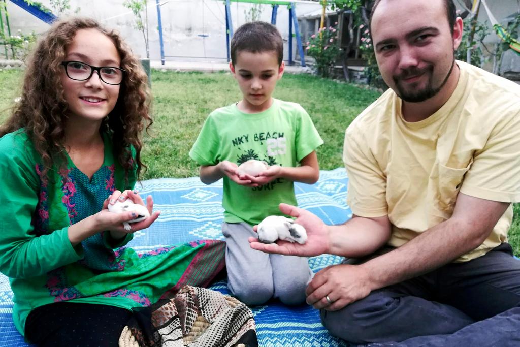 Ryan Corbett holding rabbits with his daughter Miriam and son Caleb in Kabul, Afghanistan in 2020