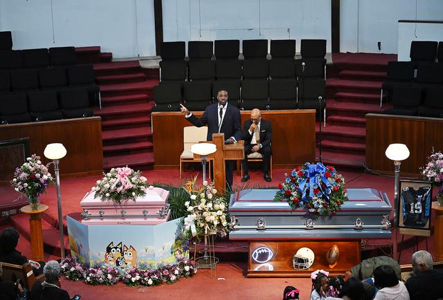 Pastor Solomon Kinloch speaks during the eulogy for A'millah Currie, 2, and Darnell Currie, Jr., during the funeral services at Triumph Church