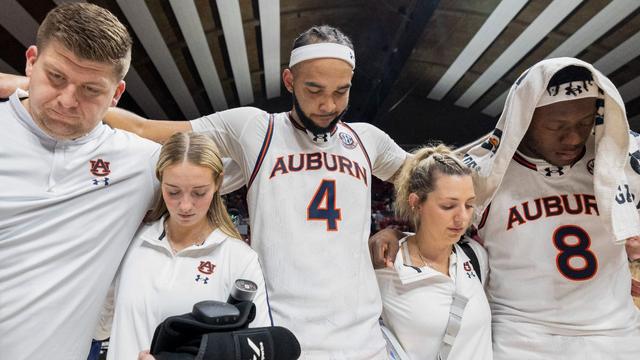 Auburn's Johni Broome (4), Ja'Heim Hudson (8) and other team personnel celebrate with a prayer after a win 