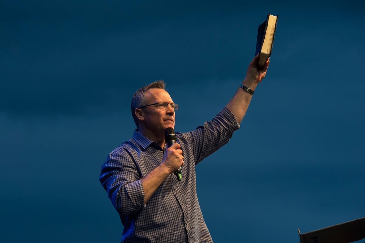 Man holding up a Bible