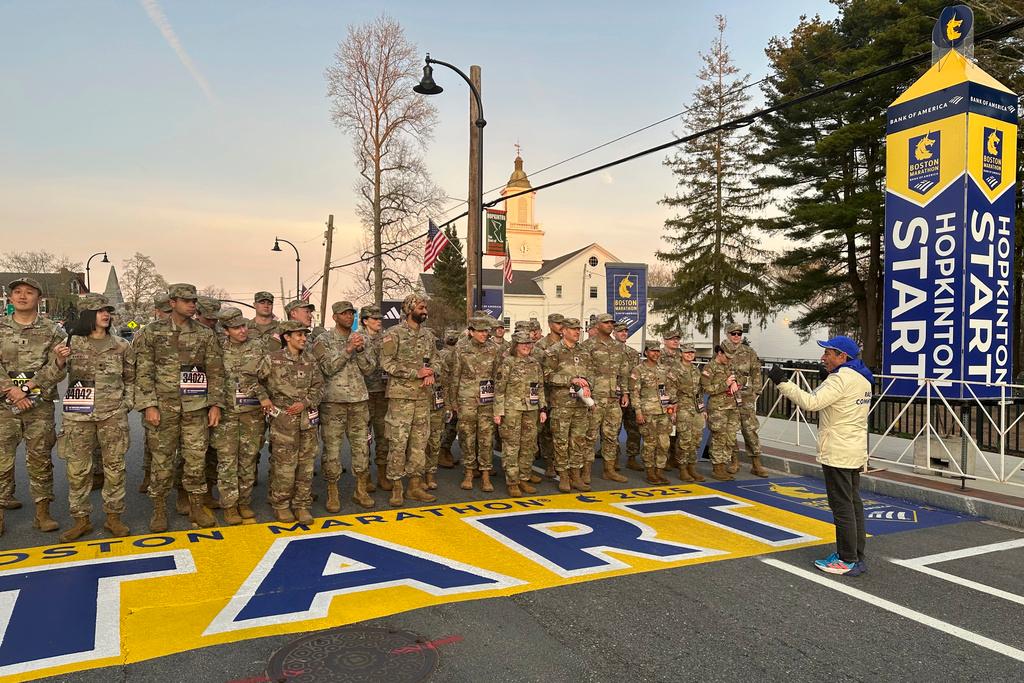 Boston Marathon Race Director Dave McGillivray, right, sends a group of Massachusetts National Guard members across the start line, launching the 129th edition of the race, in Hopkinton, Mass.