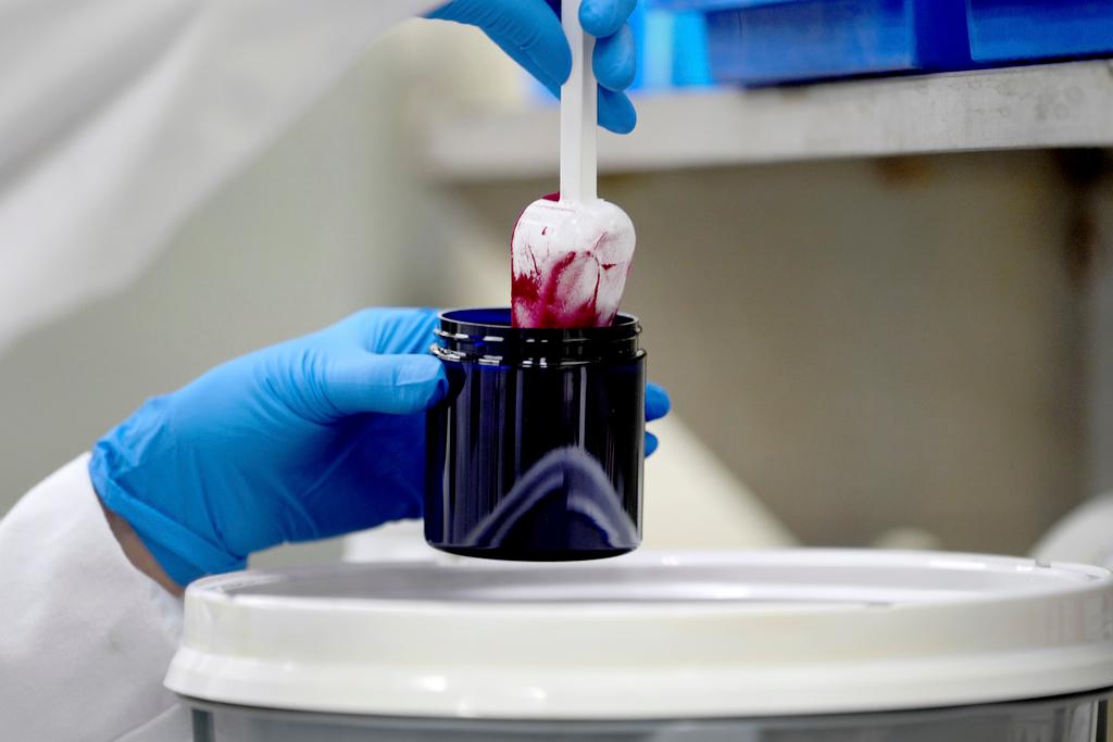 Technician Heather Browning packages a color sample made of beet powder for a customer at Sensient Technologies Corp., a color additive manufacturing company, in St. Louis