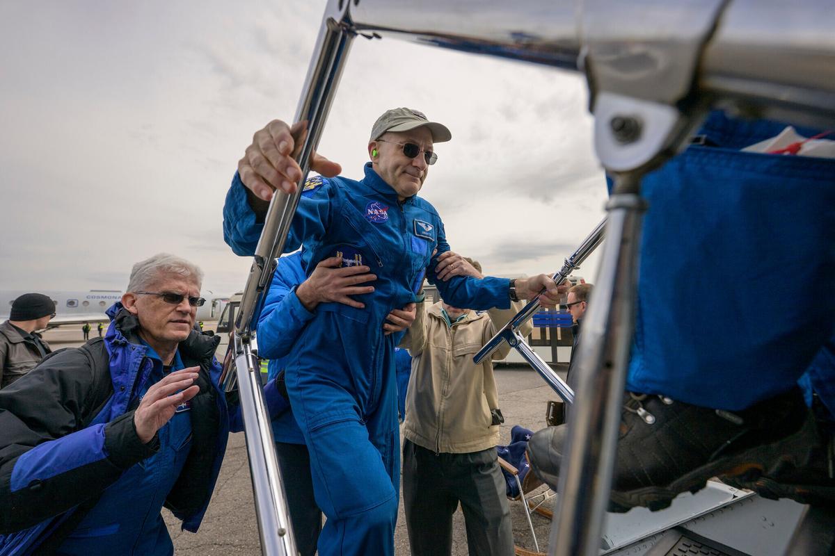 Man being loaded onto spacecraft
