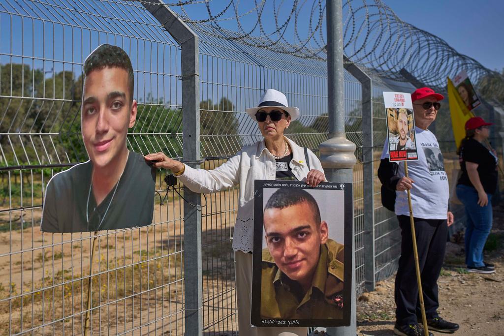 Varda Ben Baruch holds a picture of her grandson Edan Alexander, who is held hostage in Gaza, gathers with other families to call out on loudspeakers in hopes that their loved ones will hear them, near the Gaza border in Kibbutz Nir Oz, southern Israel, April 20, 2025