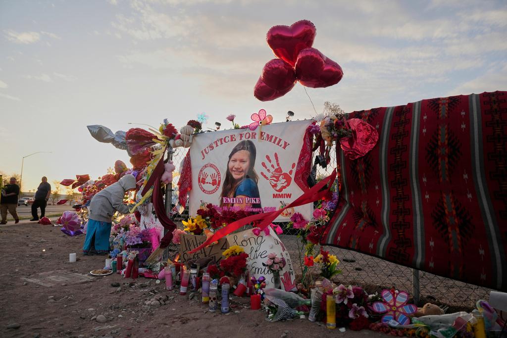 A tribute to slain Native American teen Emily Pike adorns a fence near a vigil in her honor in Mesa, Ariz.,