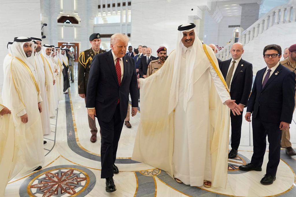 Qatar's Emir Sheikh Tamim bin Hamad Al Thani welcomes President Donald Trump during an official welcoming ceremony at the Amiri Diwan in Doha, Qatar
