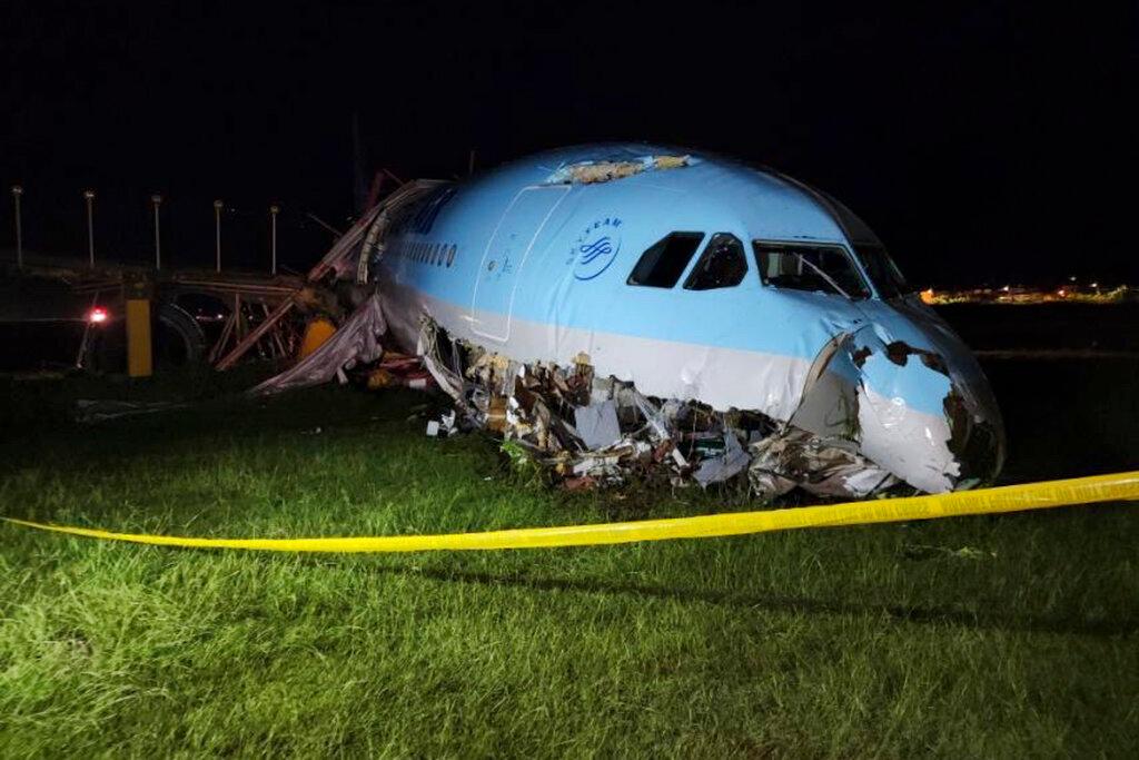 A damaged portion of the Korean Air Lines Co. plane lies after it overshot the runway at the Mactan Cebu International Airport in Cebu, central Philippines