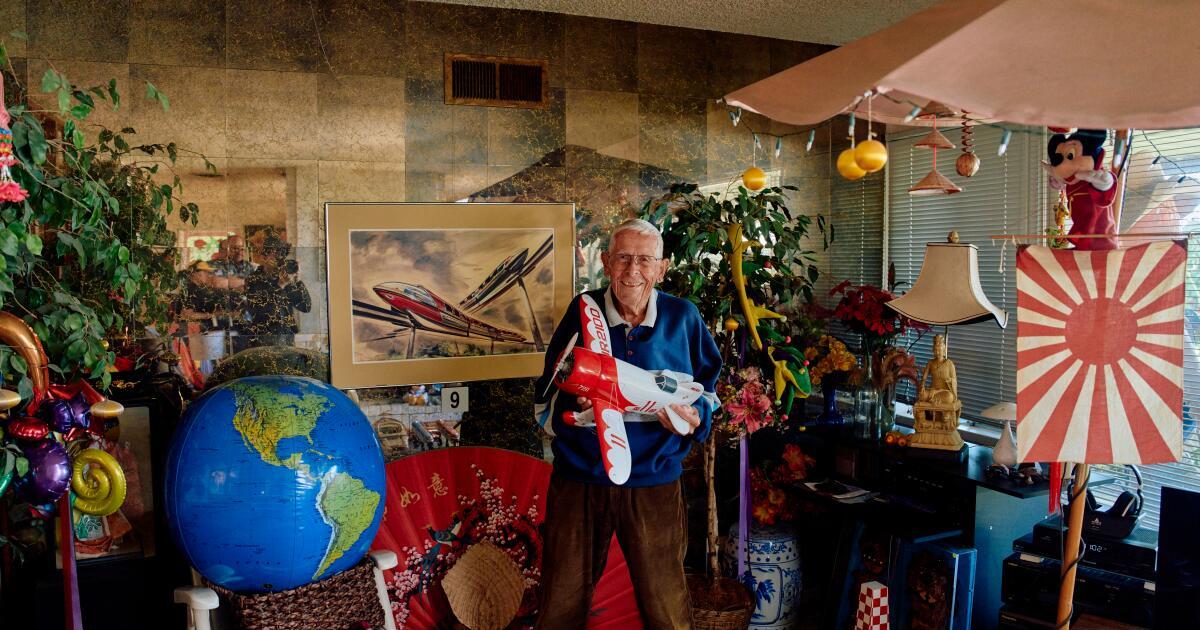 Man in a room filled with memorabilia